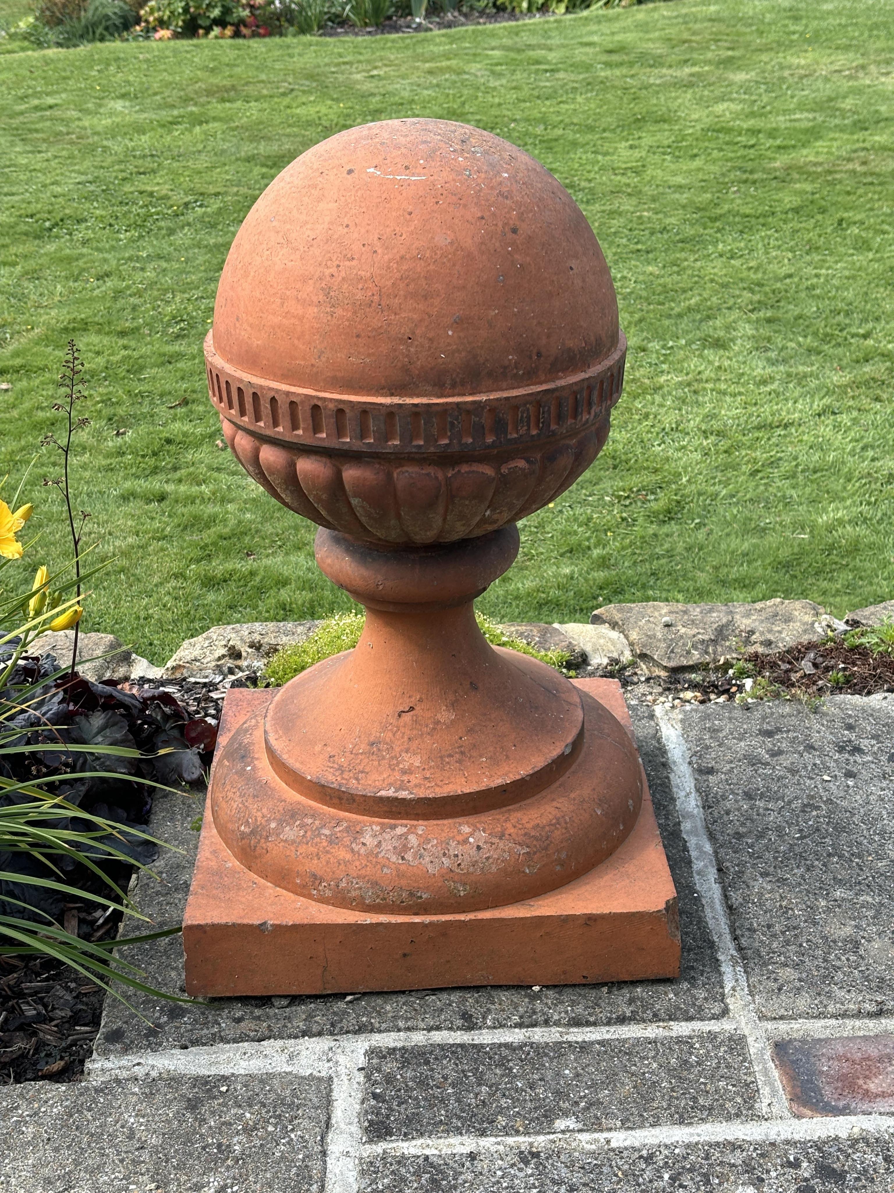 A large pair of Victorian terracotta ball finials, height 64cm, diameter 46cm. Condition -weathered, some chipping to the bases